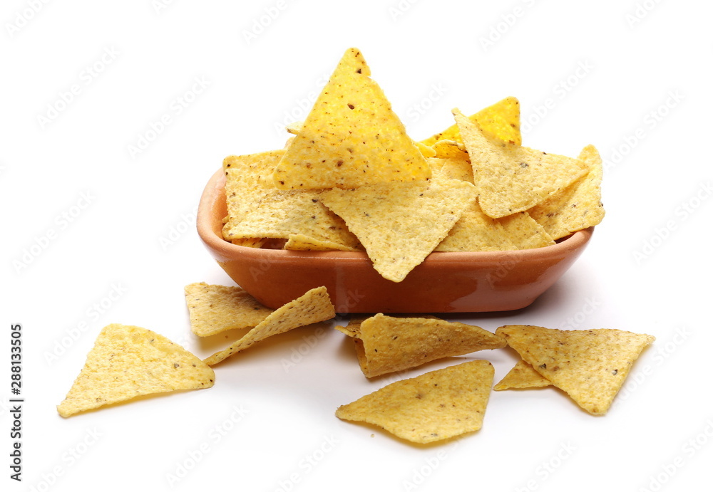 Corn tortilla chips pile in clay pot, bowl isolated on white background Corn tortilla chips pile in clay pot, bowl isolated on white background