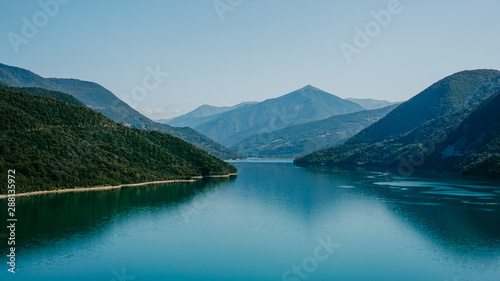 Zhinvali reservoir lake landscape with mountains . The main Caucasus ridge. photo