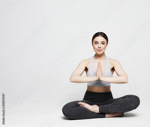 sport, yoga and people concept - lovely young woman doing yoga, sports exercises for relaxation and meditation