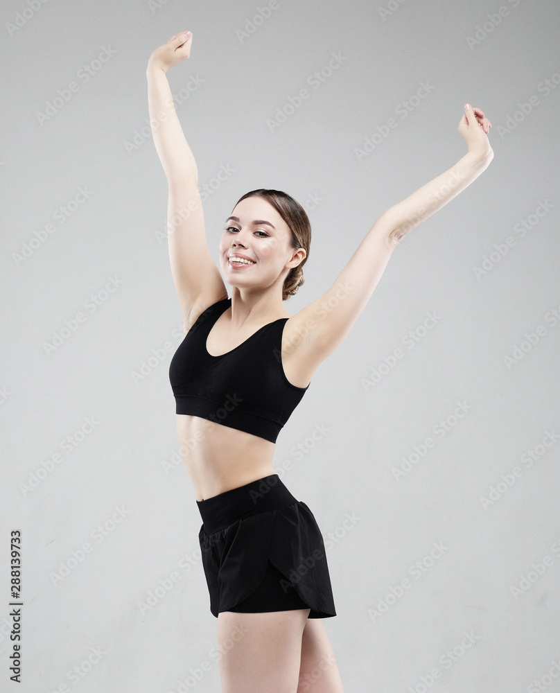 lovely young woman in sportswear posing on a white background, sport concept