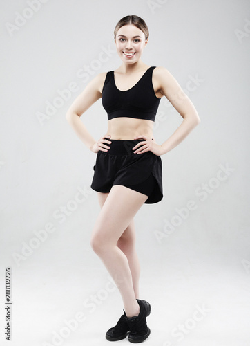 lovely young woman in sportswear posing on a white background, sport concept