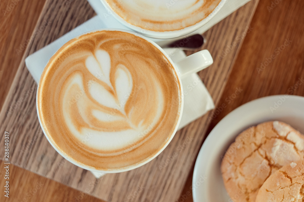 Morning coffee lifestyle. Cup of cappuccino with cookies on a wooden table. Morning coffee lifestyle. Cup of cappuccino with cookies on a wooden table.