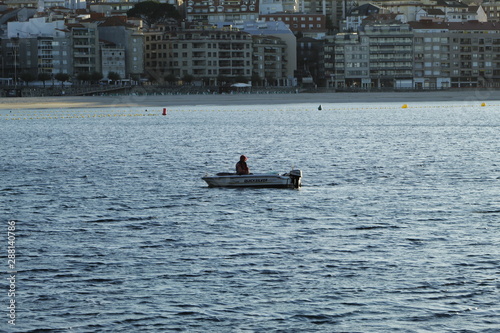 Fisherman in small boat in the city of Sanxenxo, in Galicia, Spain