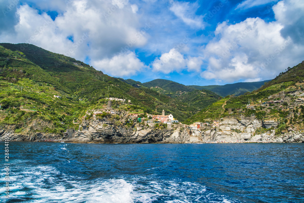 The rocky shore of Cinque Terre, overgrown with tropical greenery and vineyards. View from the sea, Monterosso al Mare, Italy