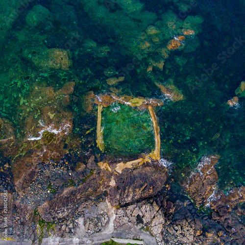 Tidal Swimming Pool on the coast at Mousehole Cornwall aerial view photo