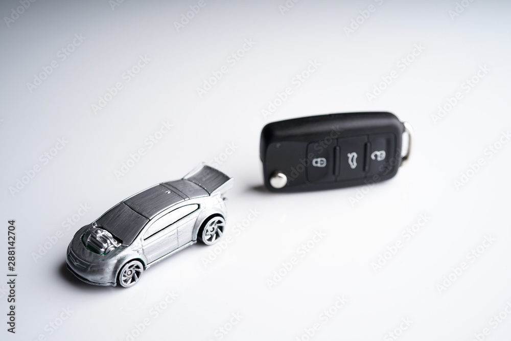 Car loan, Insurance, buy and sell and Auto Finance conceptual image with Car Key remote, die cast car and dollar bills Car loan, Insurance, buy and sell and Auto Finance conceptual image with Car Key remote, die cast car and dollar bills