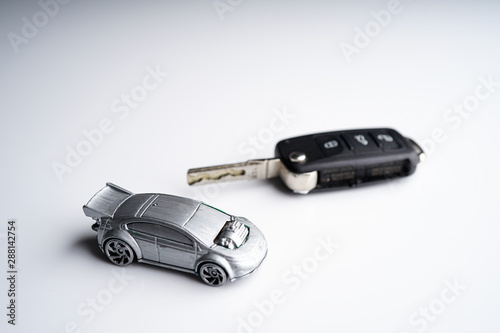 Car loan, Insurance, buy and sell and Auto Finance conceptual image with Car Key remote, die cast car and dollar bills 