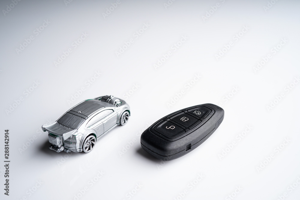 Car loan, Insurance, buy and sell and Auto Finance conceptual image with Car Key remote, die cast car and dollar bills Car loan, Insurance, buy and sell and Auto Finance conceptual image with Car Key remote, die cast car and dollar bills