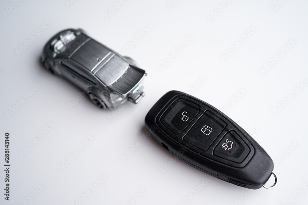Car loan, Insurance, buy and sell and Auto Finance conceptual image with Car Key remote, die cast car and dollar bills Car loan, Insurance, buy and sell and Auto Finance conceptual image with Car Key remote, die cast car and dollar bills