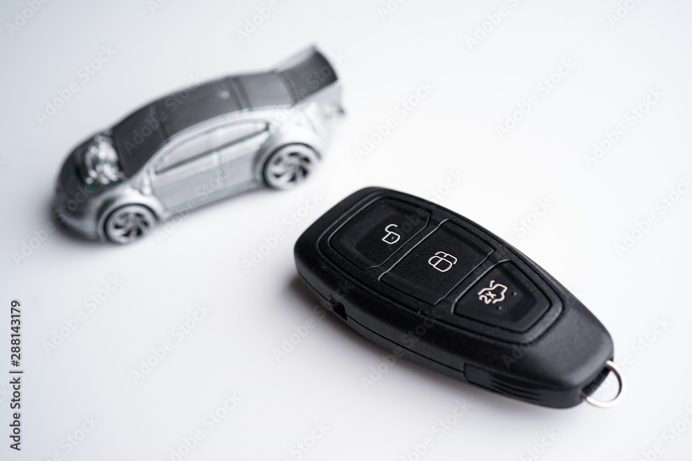 Car loan, Insurance, buy and sell and Auto Finance conceptual image with Car Key remote, die cast car and dollar bills 