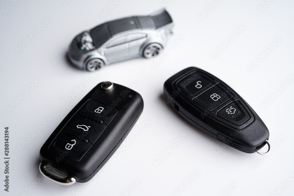 Car loan, Insurance, buy and sell and Auto Finance conceptual image with Car Key remote, die cast car and dollar bills Car loan, Insurance, buy and sell and Auto Finance conceptual image with Car Key remote, die cast car and dollar bills