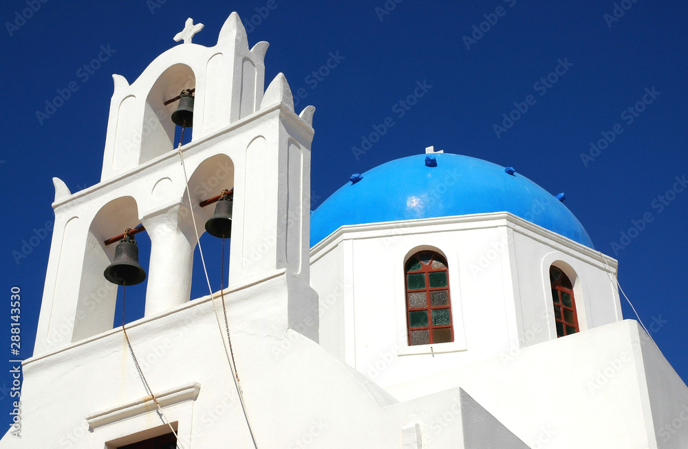 A blue domed church in Santorini, Greece. Santorini is famous for its blue and white churches. Santorini has many pretty blue and white buildings. Church in Santorini, Greece, blue dome, white walls.