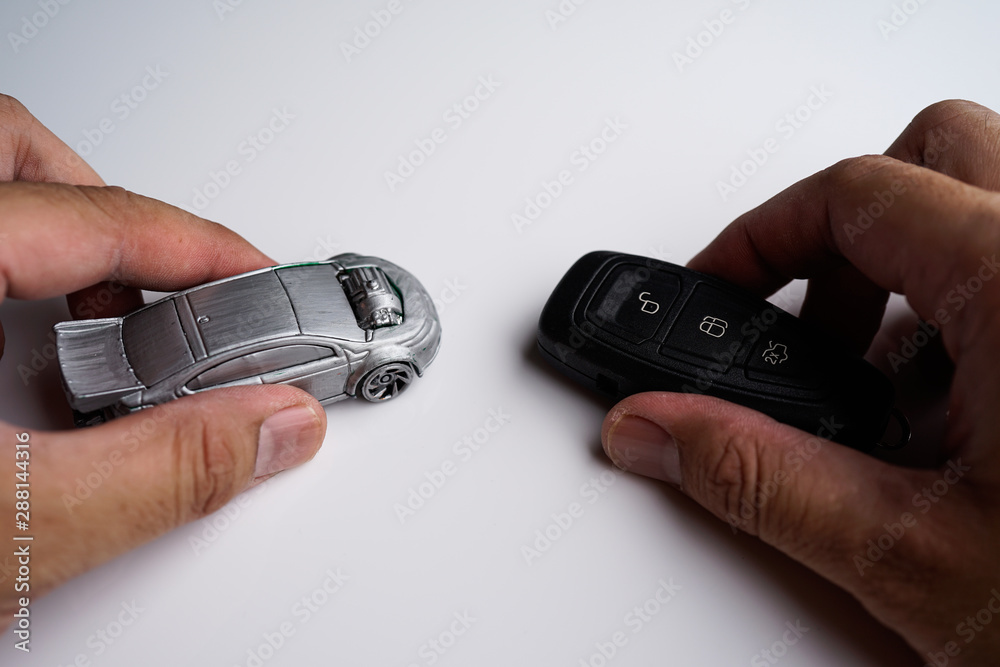 Car loan, Insurance, buy and sell and Auto Finance conceptual image with Car Key remote, die cast car and dollar bills Car loan, Insurance, buy and sell and Auto Finance conceptual image with Car Key remote, die cast car and dollar bills