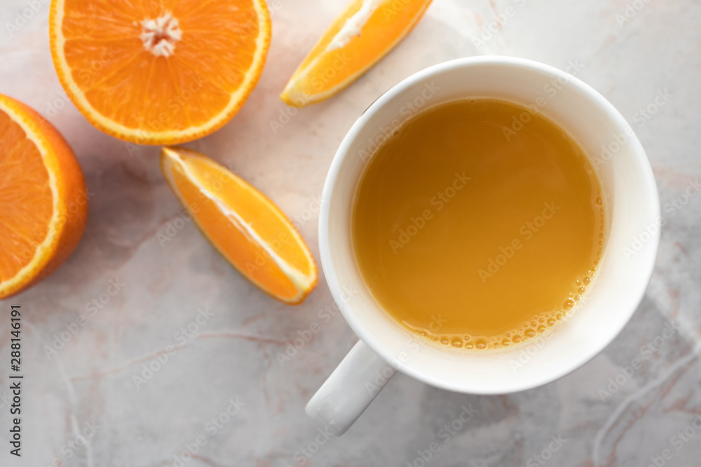 Top view of cut oranges and cup of fresh squeezed orange juice Top view of cut oranges and cup of fresh squeezed orange juice