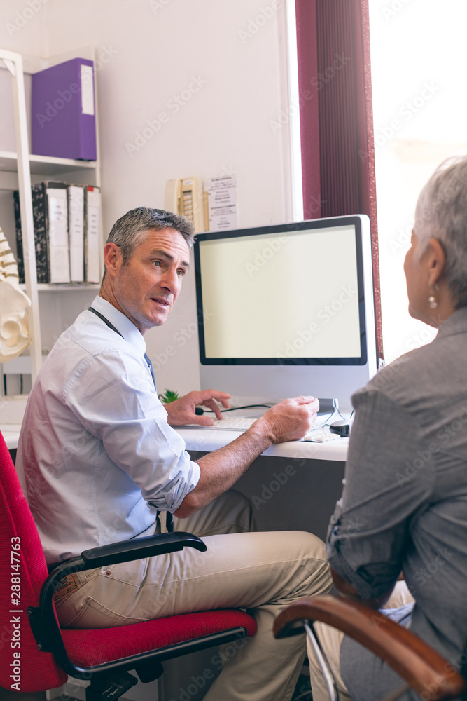 Obraz premium Male doctor and senior woman interacting with each other 