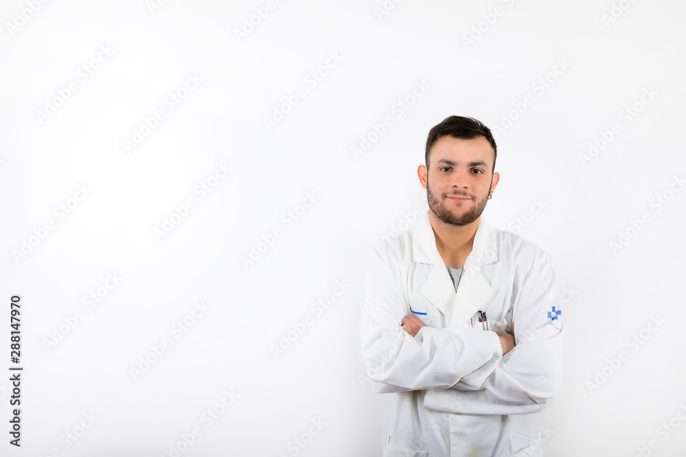 Smiling and willing Young male doctor with beard with arms folded isolated on white background Smiling and willing Young male doctor with beard with arms folded isolated on white background