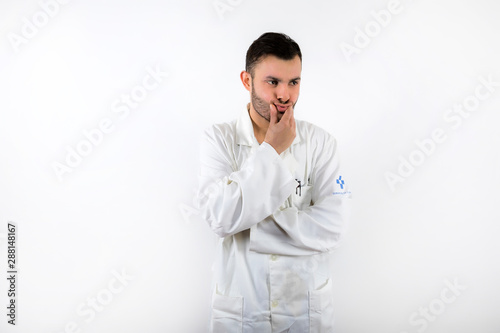 Young male doctor with beard worried and upset isolated on white background © Hernán