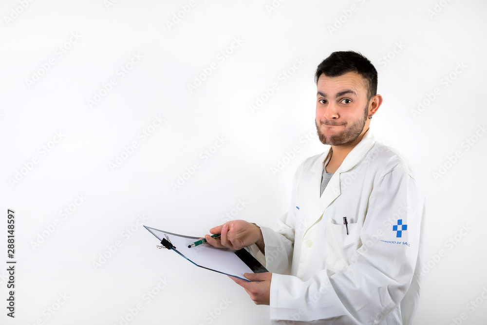 Young male doctor with beard pointing medical report isolated on white background Young male doctor with beard pointing medical report isolated on white background