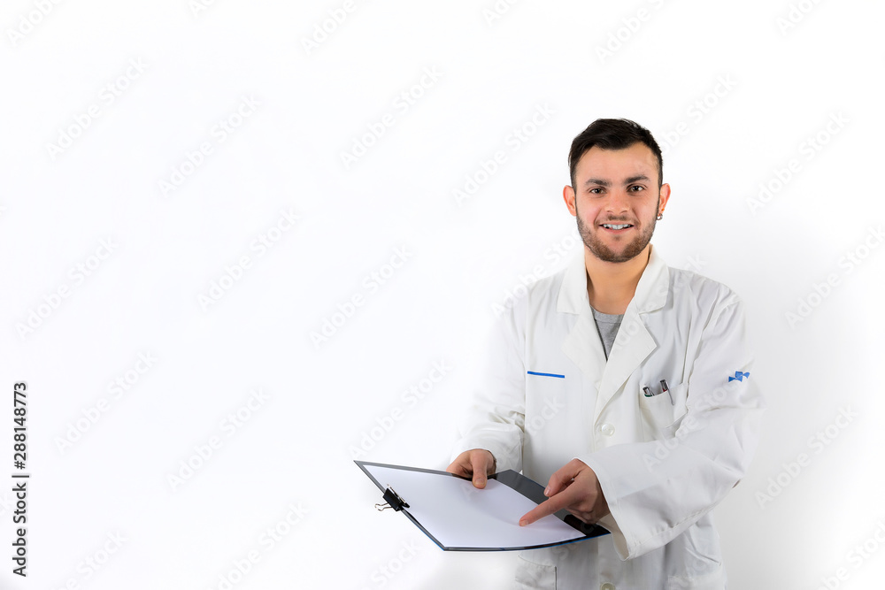 Smiling and willing Young male doctor with beard pointing medical report isolated on white background Smiling and willing Young male doctor with beard pointing medical report isolated on white background