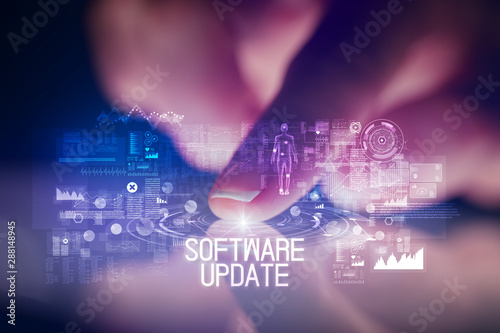 Finger touching tablet with web technology icons and SOFTWARE UPDATE inscription