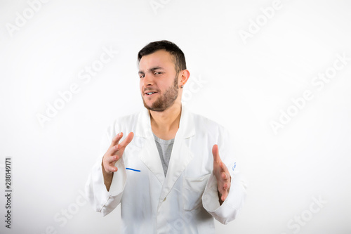 Young male doctor with beard shaking hand like Giorgio Tsoukalos saying "im not saying it was aliens but it was aliens" isolated on white background