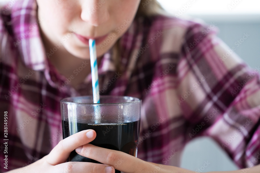 Close Up Of Girl Drinking Sugary Fizzy Soda From Glass With Straw Close Up Of Girl Drinking Sugary Fizzy Soda From Glass With Straw