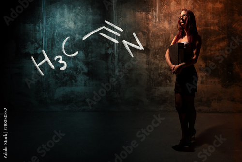Sexy girl or secretary or female student presenting handdrawn chemical formula of acetonitrile photo