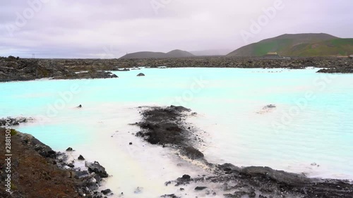 lava rocks over blue lagoon water photo