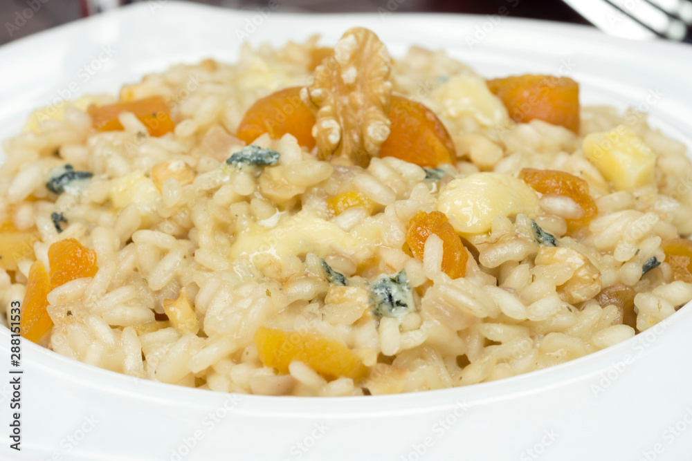 Gorgonzola cheese risotto with damascus and walnuts Gorgonzola cheese risotto with damascus and walnuts