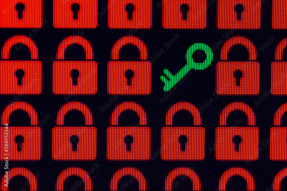 Key as a symbol of access or hacking of open personal information. Red pixel locks and a green key on a black background, close-up Key as a symbol of access or hacking of open personal information. Red pixel locks and a green key on a black background, close-up