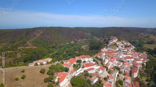 Aerial, drone shot, panning around the village, revealing the Aljezur  castle, on a sunny day, in Vicentine coast national park, in Algarve, Portugal photo