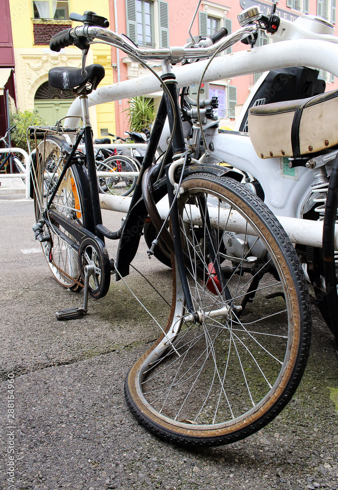 Old broken bicycle with a crooked wheel Old broken bicycle with a crooked wheel