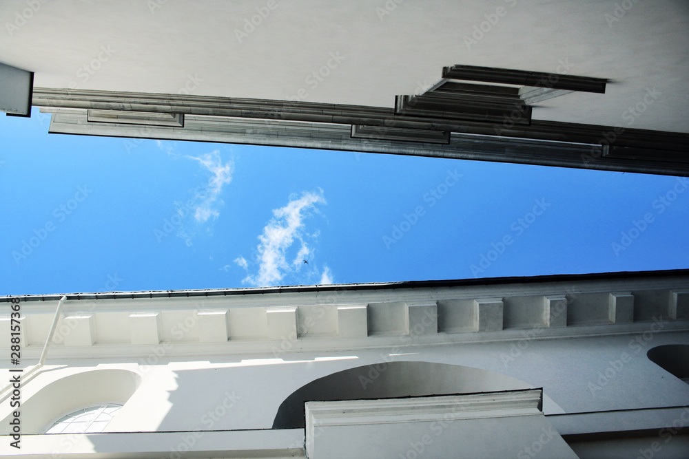 Fototapeta premium Blue sky between two white historical buildings