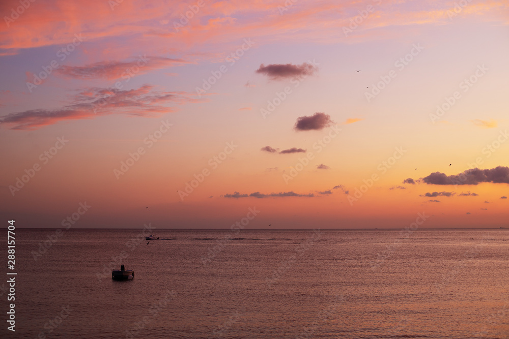 beautiful sunset, boat in water, clouds