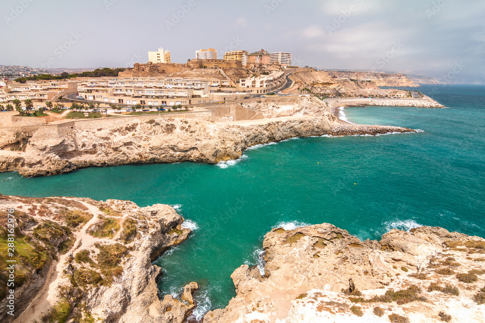 Melilla, a Spanish province bordering with Morocco in Africa. View of the city walls on the rocky coast of the Mediterranean Sea.