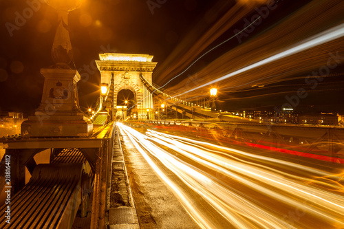 The famous Chain Bridge in Budapest, Hungary. Long exposure with light trails of cars at a night.