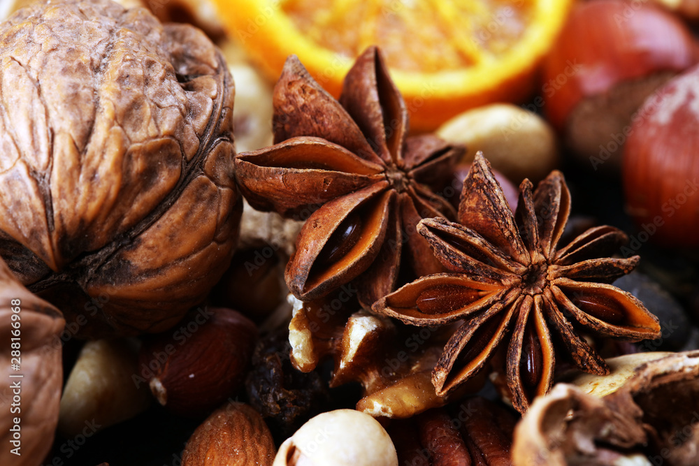 Composition with dried fruits and assorted healthy nuts on rustic background for christmas Composition with dried fruits and assorted healthy nuts on rustic background for christmas