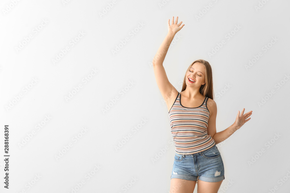 Cool young woman dancing against white background Cool young woman dancing against white background