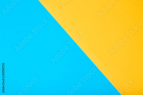 Yellow and blue two tone color paper background.