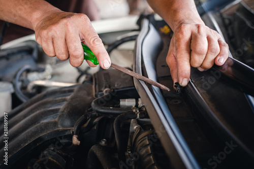 Hands of mechanic working in auto repair shop.