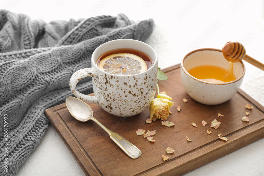 Cup of hot tea with lemon, honey and flower on table - obrazy, fototapety, plakaty 