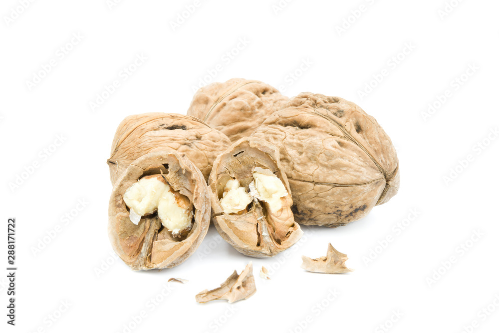 Whole and broken walnuts isolated on white background. Whole and broken walnuts isolated on white background.