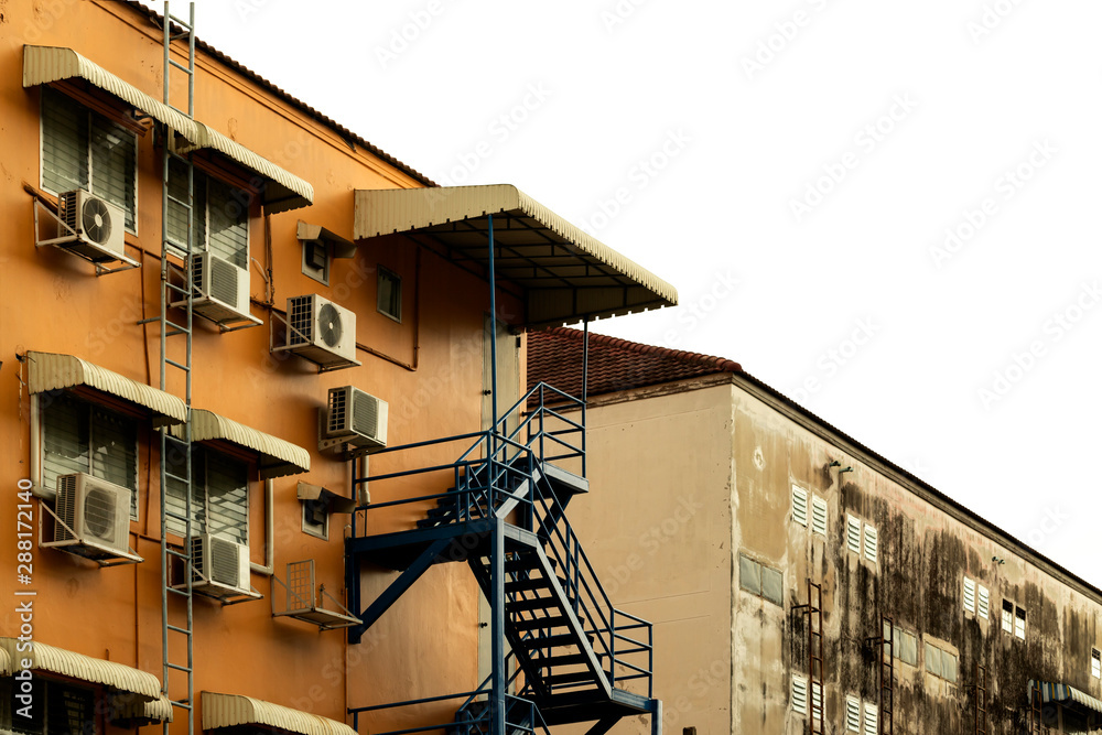 Fire escape ladder and air compressor behind the condominium.