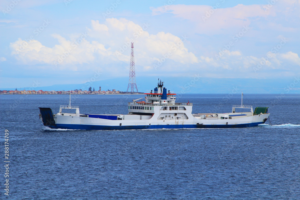 Ferry in the strait of Messina with Torre Faro of Sicily and mainland of Italy in background