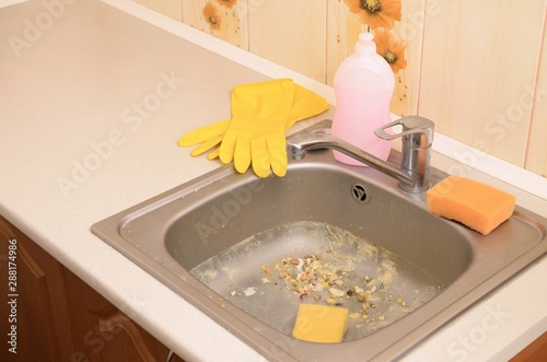 Close up on dirty clogging kitchen sink drain with food particles photo