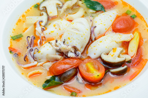 Squids and lemon grass spicy soup with mushrooms, tomatoes and herbs