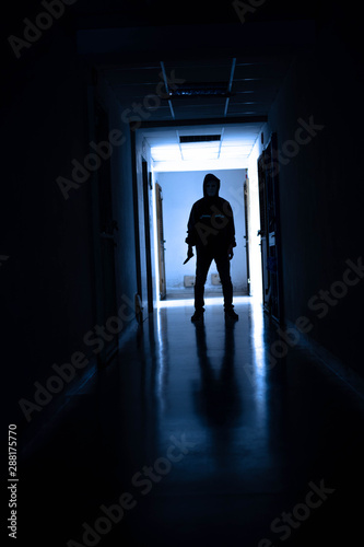 Murder wear the mask holding a knife and Standing in the old apartment  kill and people concept - Criminal or murderer with blood on knife at crime scene.