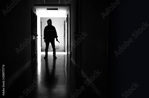 Murder wear the mask holding a knife and Standing in the old apartment  kill and people concept - Criminal or murderer with blood on knife at crime scene.