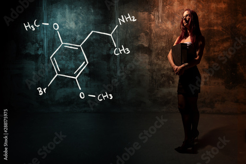 Sexy girl or secretary or female student presenting handdrawn chemical formula of Dimethoxybromoamphetamine dob photo