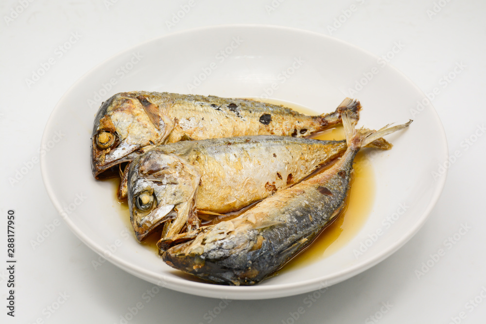 Fried mackerel on white plate. Deep fried fish Fried mackerel on white plate. Deep fried fish
